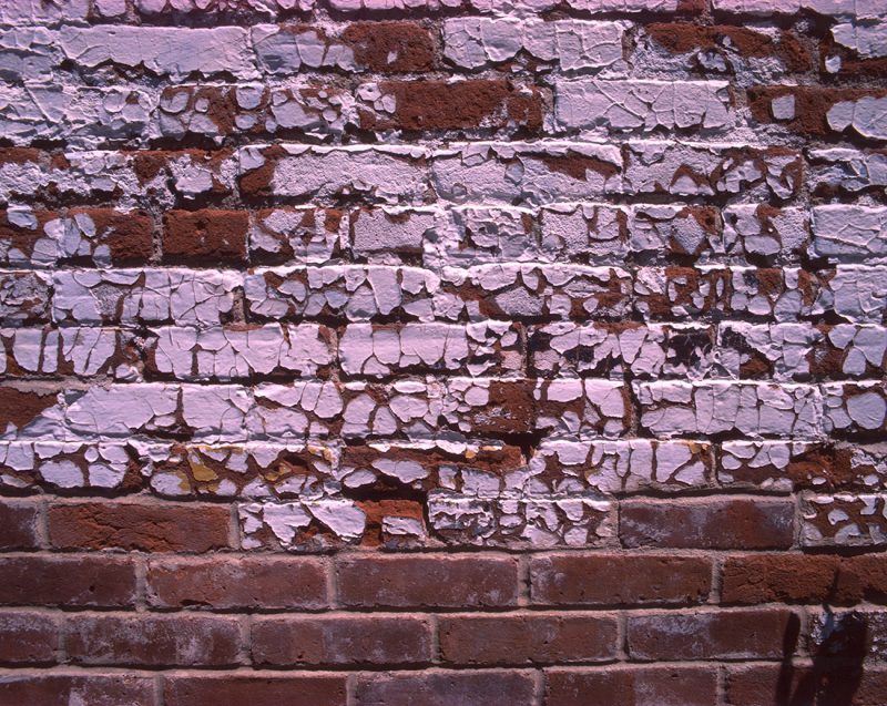 Fading paint on bricks